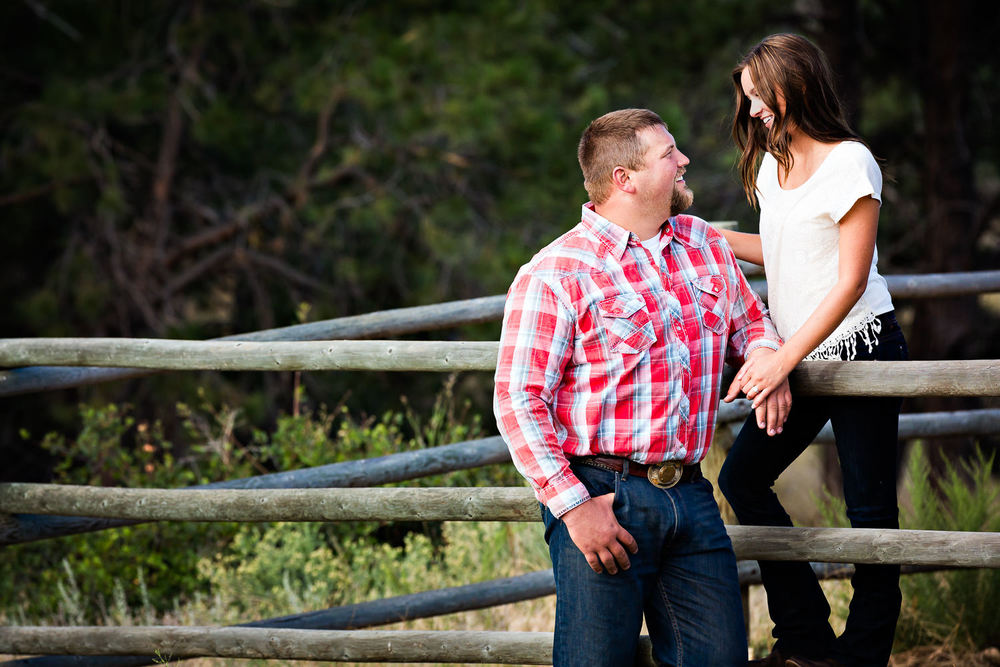 billings-montana-engagement-session-couple-leans-against-fence.jpg