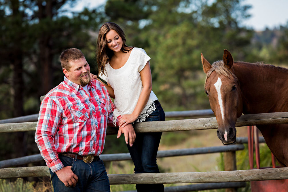 billings-montana-engagement-session-happy-couple-look-at-their-horse.jpg