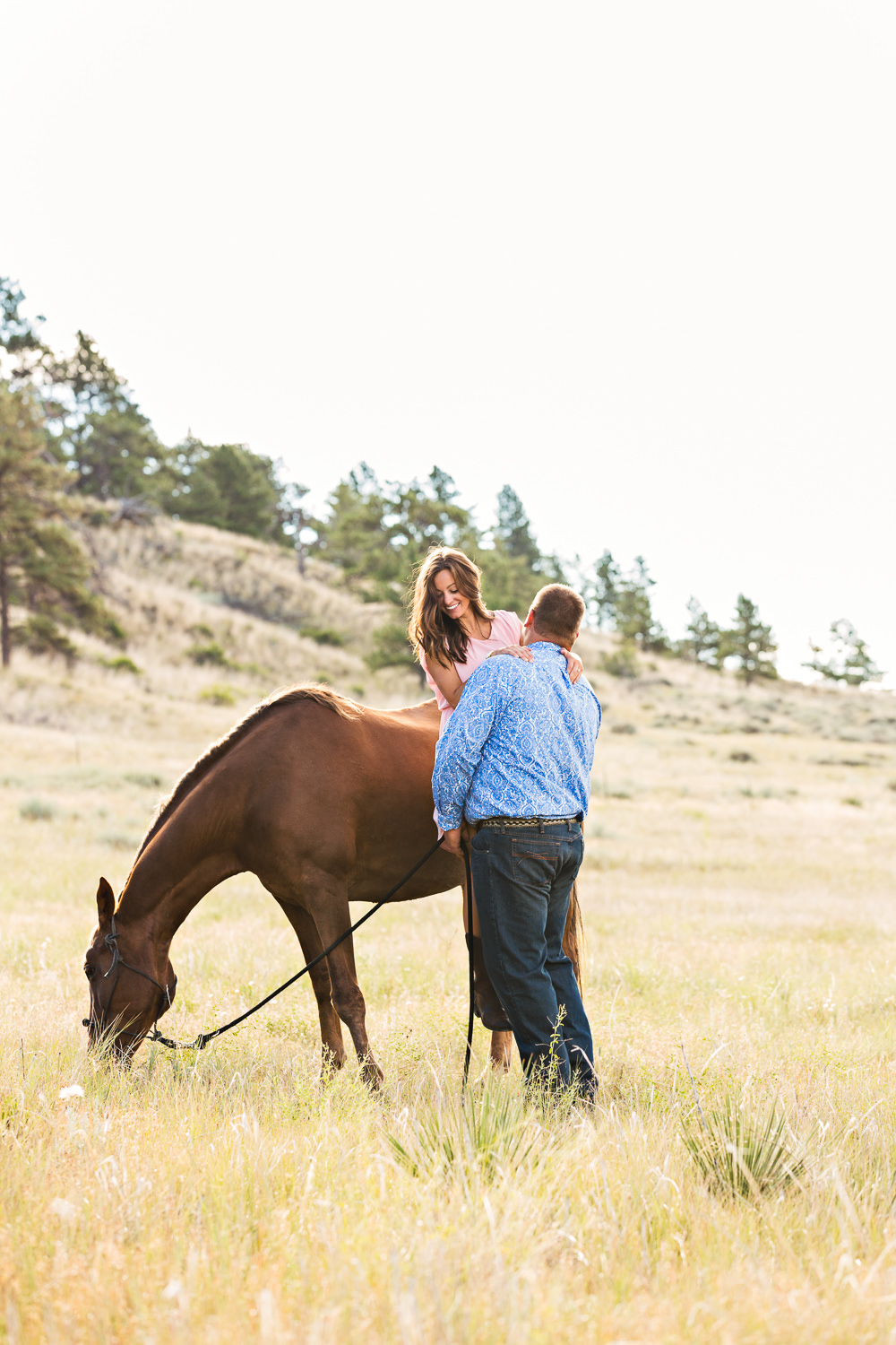 billings-montana-engagement-session-man-helps-woman-off-horse.jpg