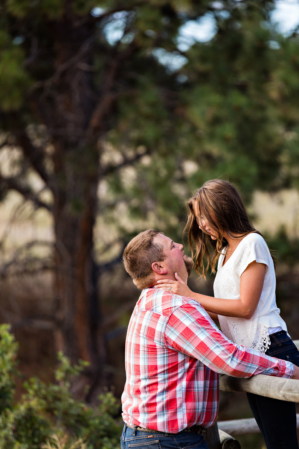 billings-montana-engagement-session-woman-leans-against-man-on-fence.jpg