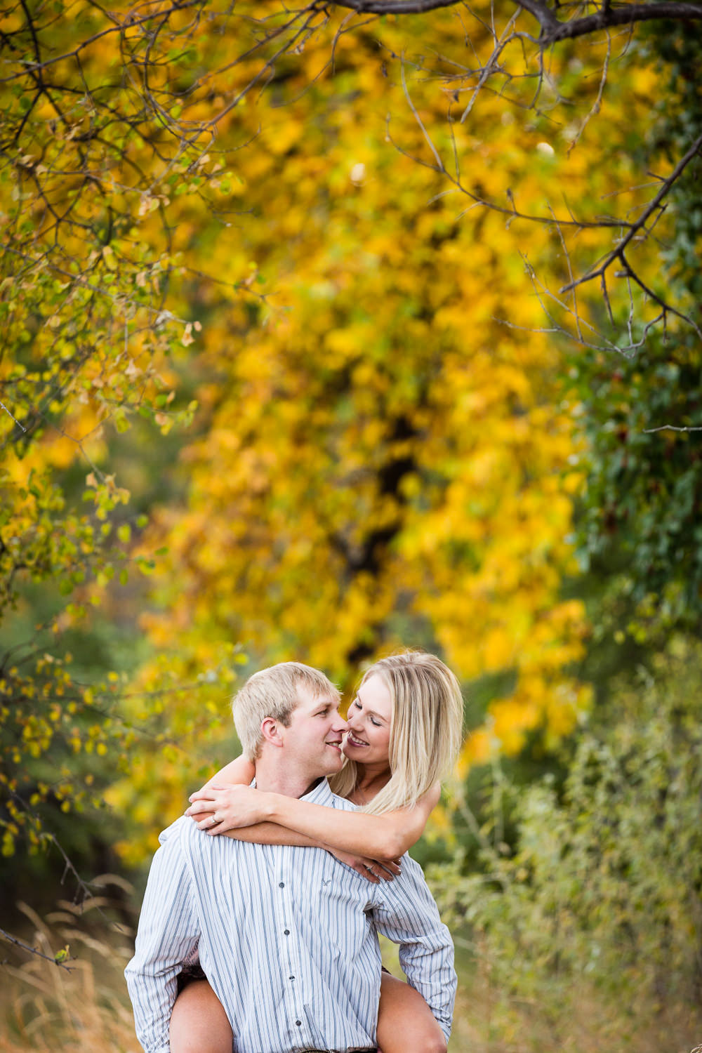 Billings-Montana-fall-engagement-playful-piggyback-ride.jpg