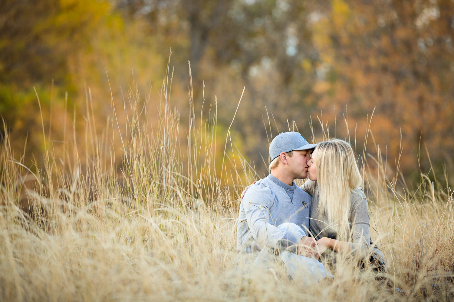Billings-Montana-fall-engagement-woman-and-man-kissing-in-field.jpg