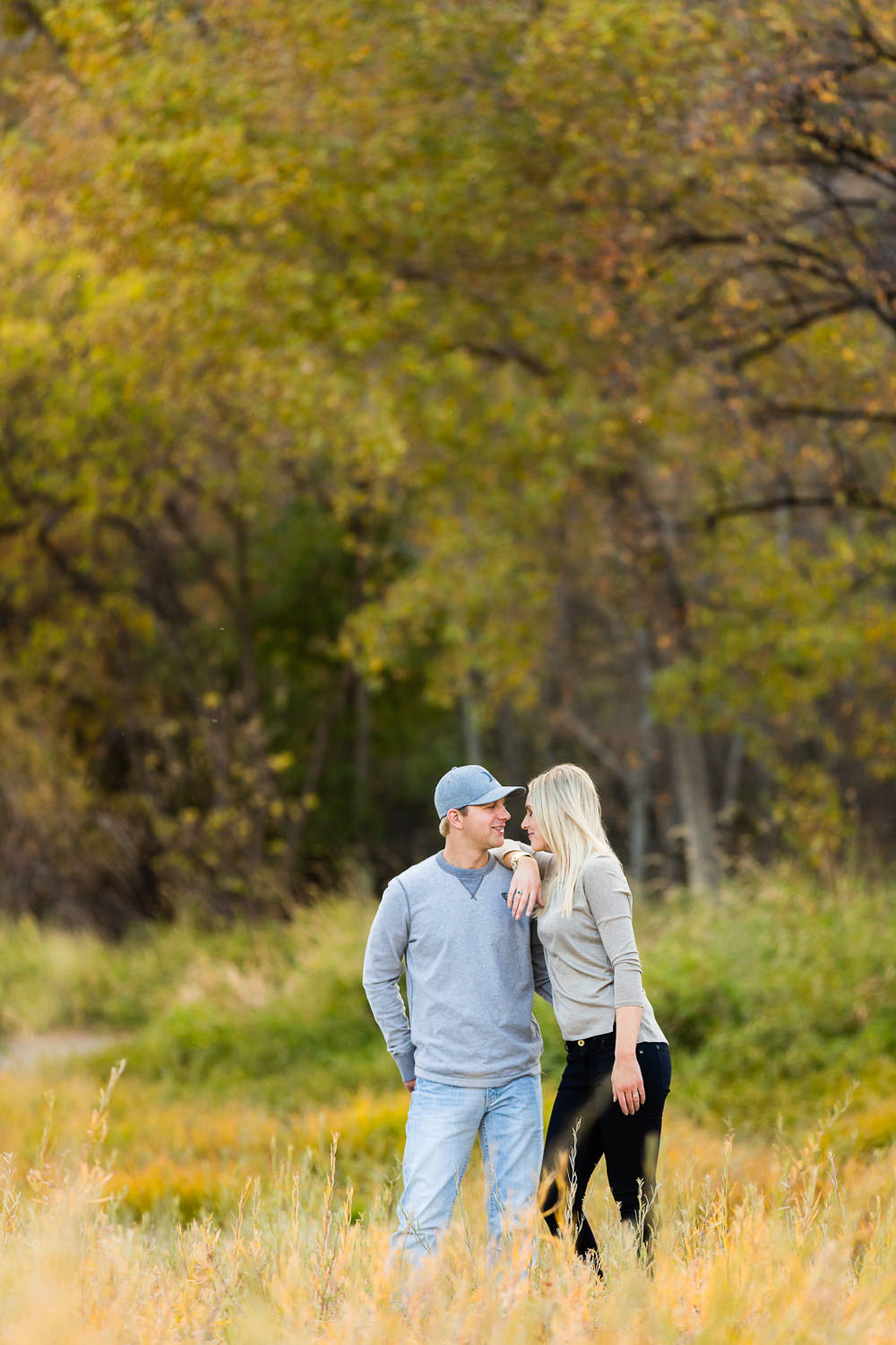 Billings-Montana-fall-engagement-woman-resting-on-mans-shoulder.jpg