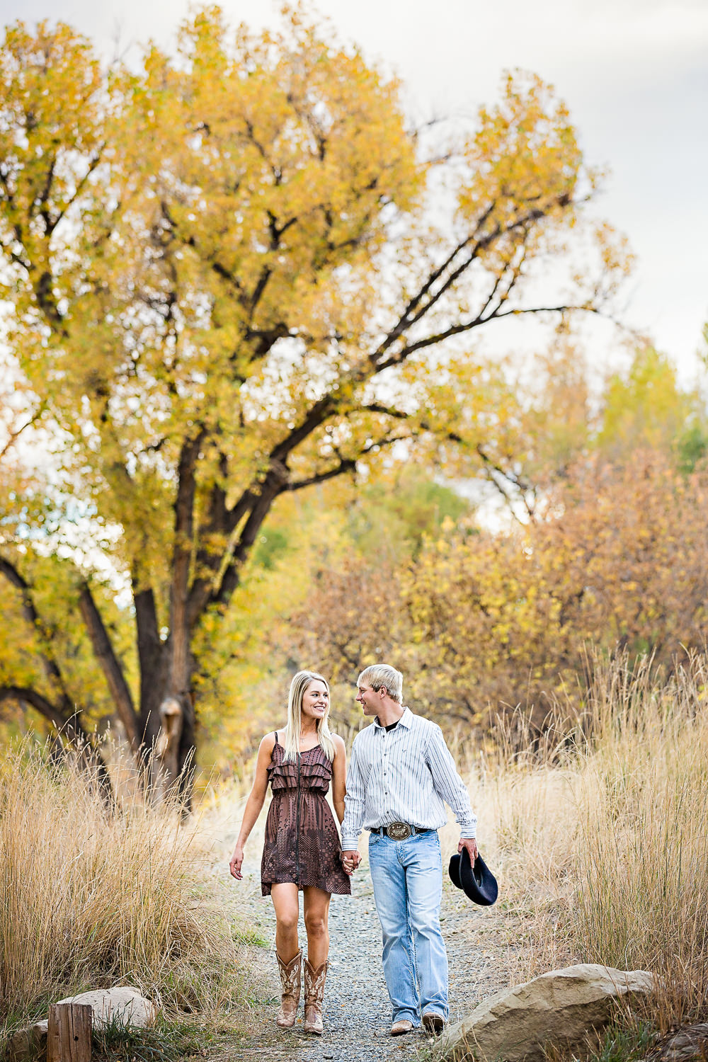 Billings-Montana-fall-engagement-woman-walks-through-park-with-her-cowboy.jpg