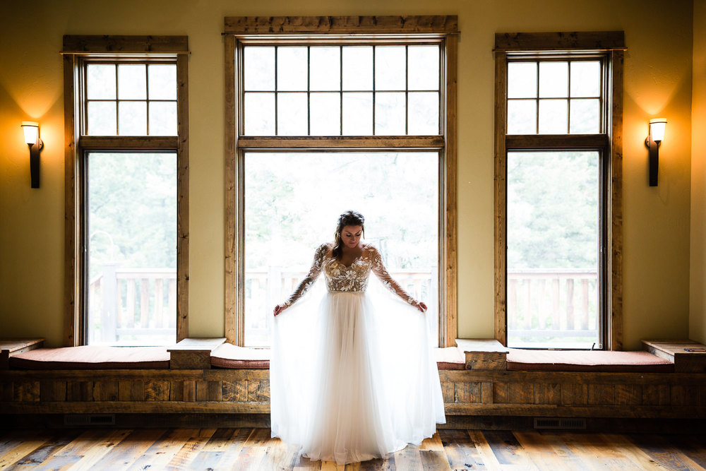 bozeman-hart-ranch-wedding-bride-plays-with-dress.jpg