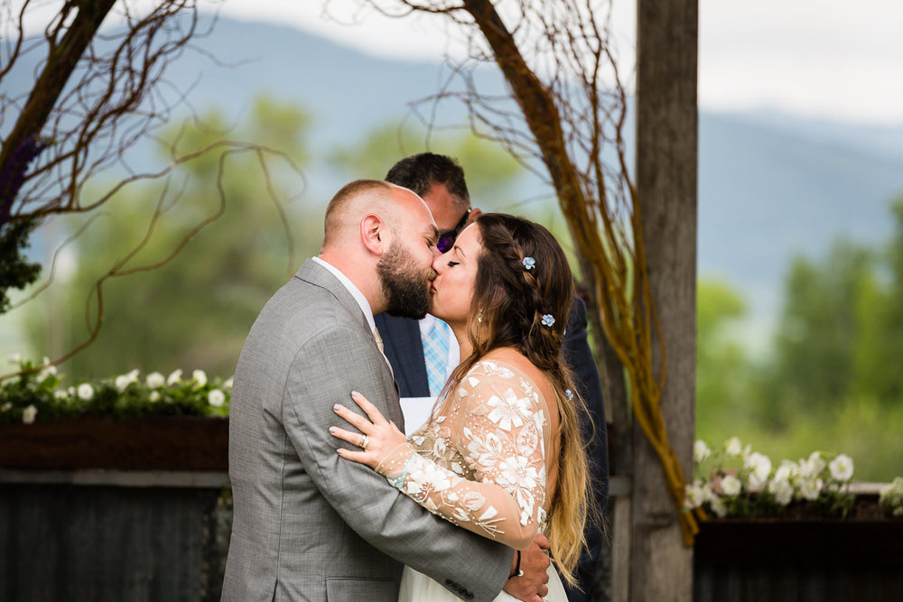 bozeman-hart-ranch-wedding-bride-groom-ceremony-kiss.jpg