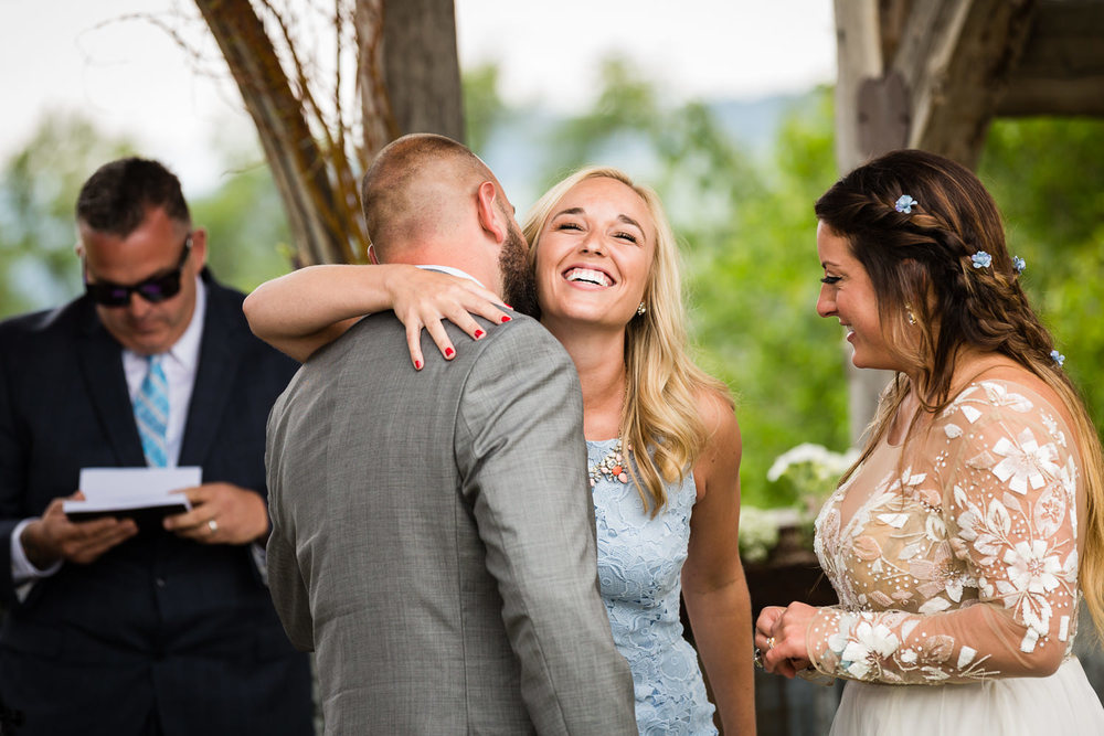 bozeman-hart-ranch-wedding-groom-hugs-friend-during-ceremony.jpg