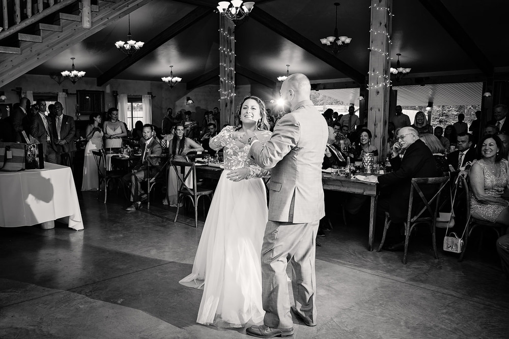 bozeman-hart-ranch-wedding-bride-groom-laugh-during-first-dance.jpg