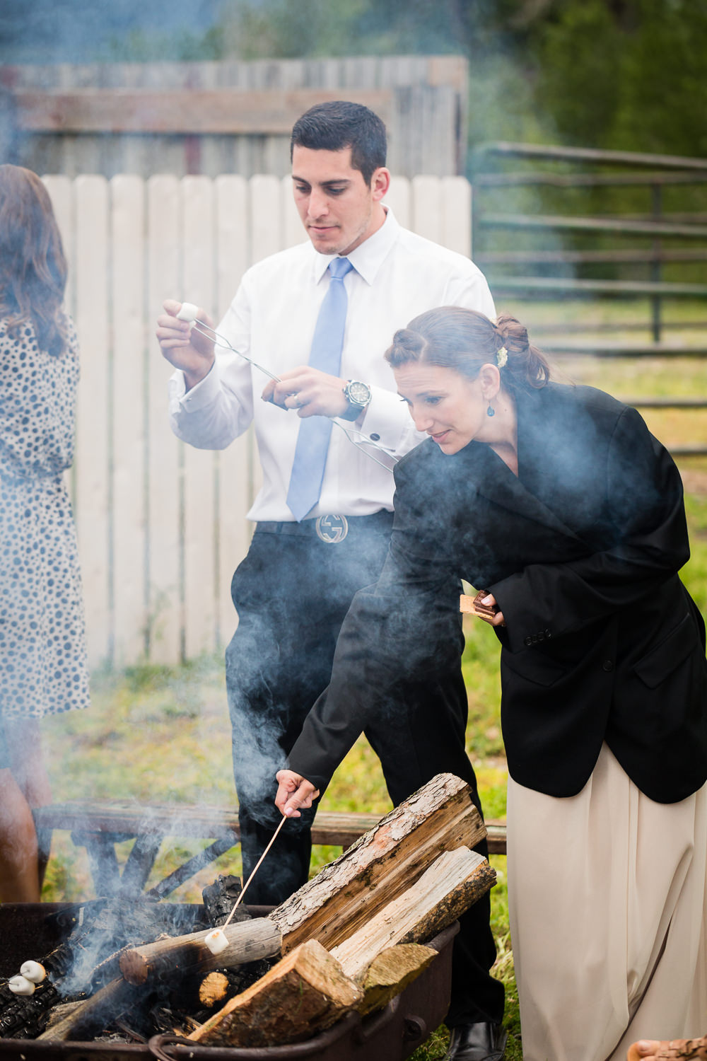 bozeman-hart-ranch-wedding-reception-guests-roasting-marshmallows.jpg