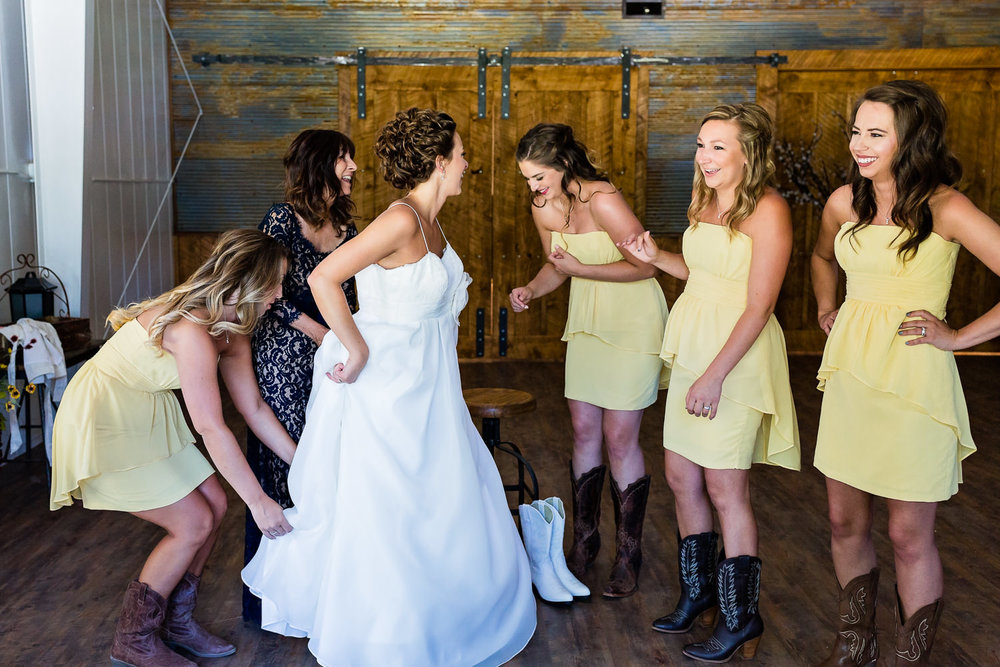 billings-montana-swift-river-ranch-wedding-bride-puts-on-dress.jpg