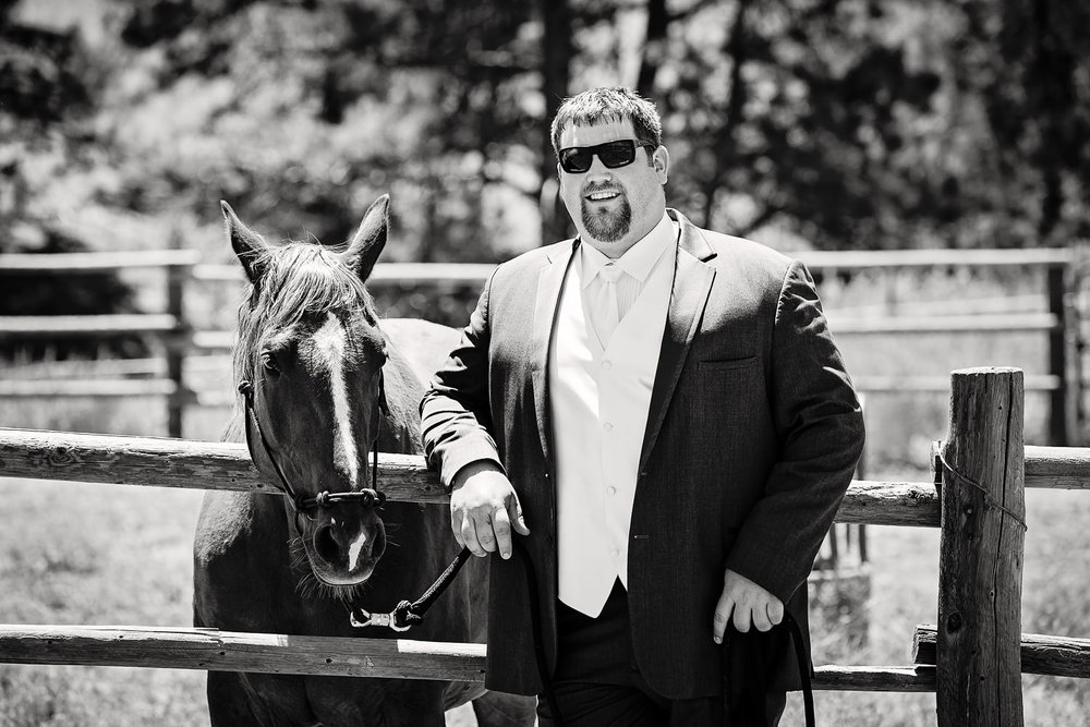 billings-montana-swift-river-ranch-wedding-groom-with-his-horse.jpg