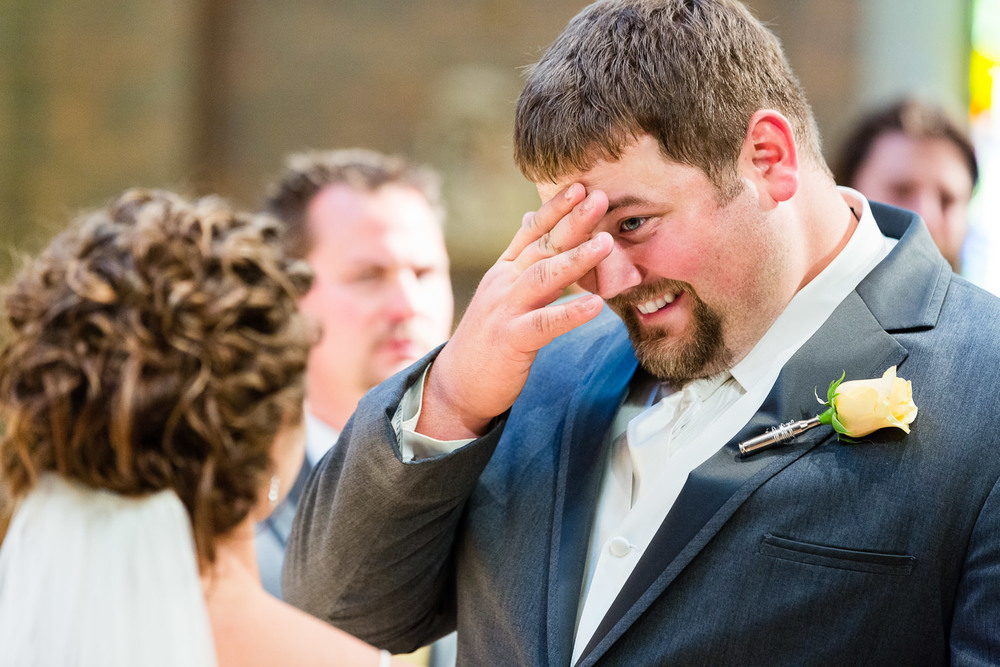 billings-montana-swift-st-thomas-groom-hides-tear.jpg