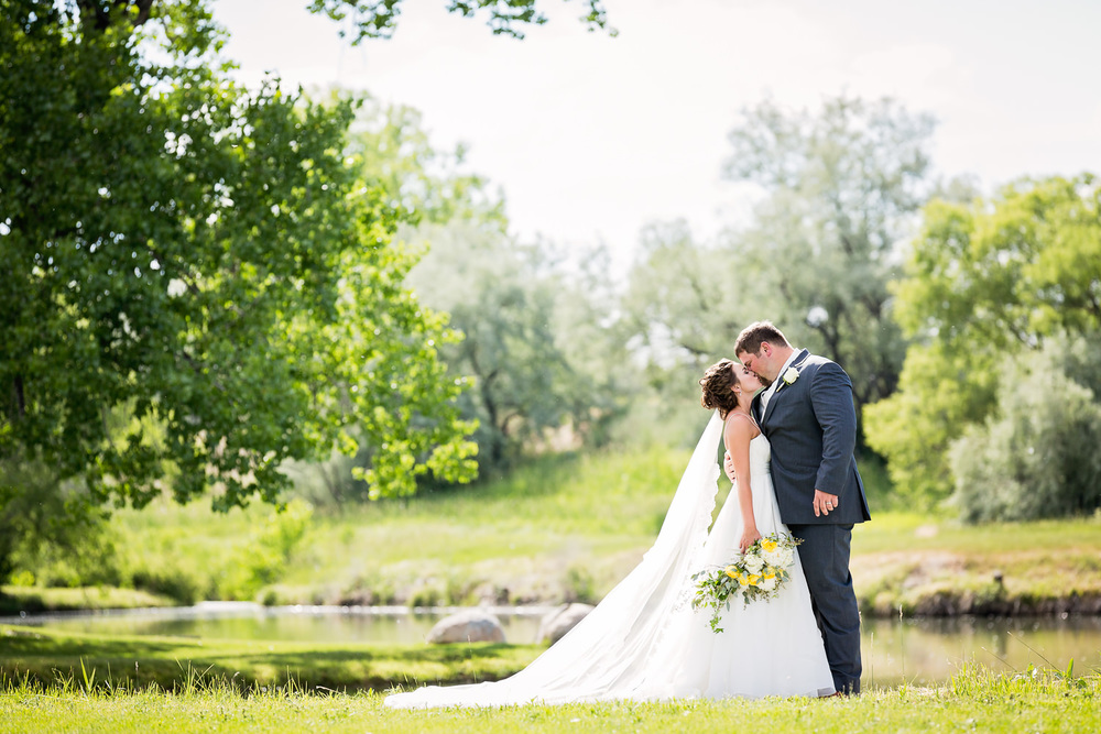 billings-montana-swift-river-ranch-wedding-reception-bride-groom-formal-kissing-in-trees.jpg
