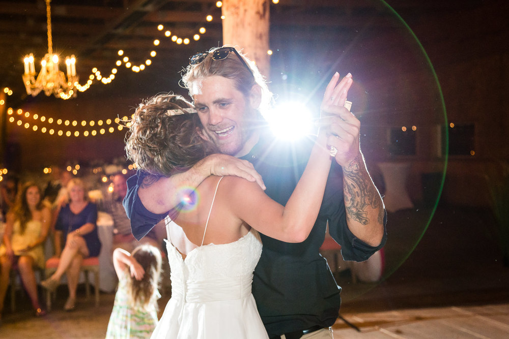 billings-montana-swift-river-ranch-wedding-reception-bride-dances-with-guest.jpg