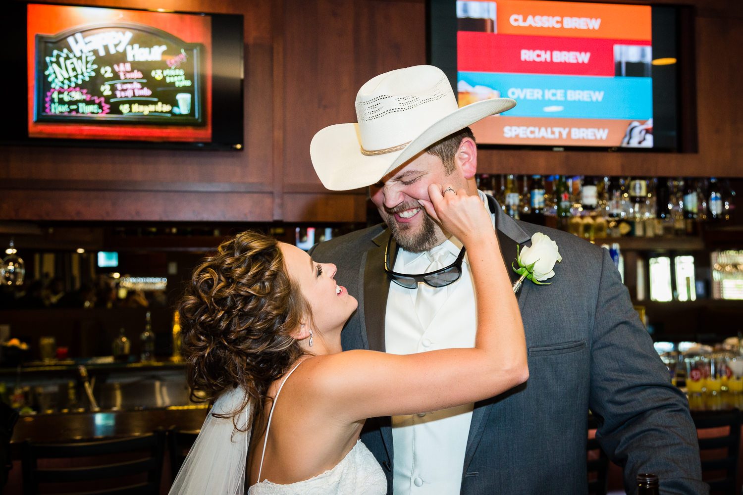 billings-montana-swift-river-ranch-wedding-reception-bride-pinches-grooms-cheek.jpg