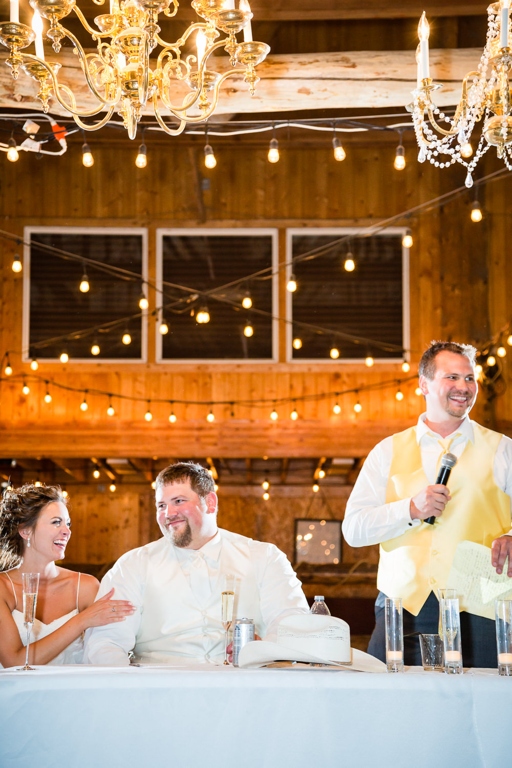 billings-montana-swift-river-ranch-wedding-reception-couple-laughing-during-toast.jpg