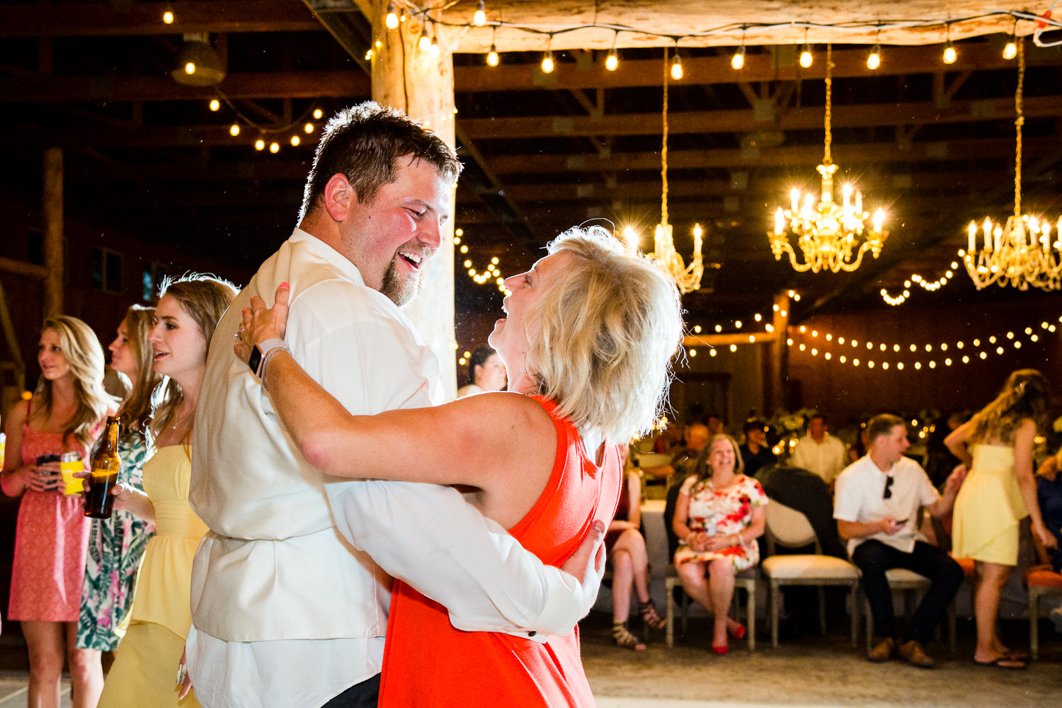 billings-montana-swift-river-ranch-wedding-reception-groom-dances-with-guest.jpg