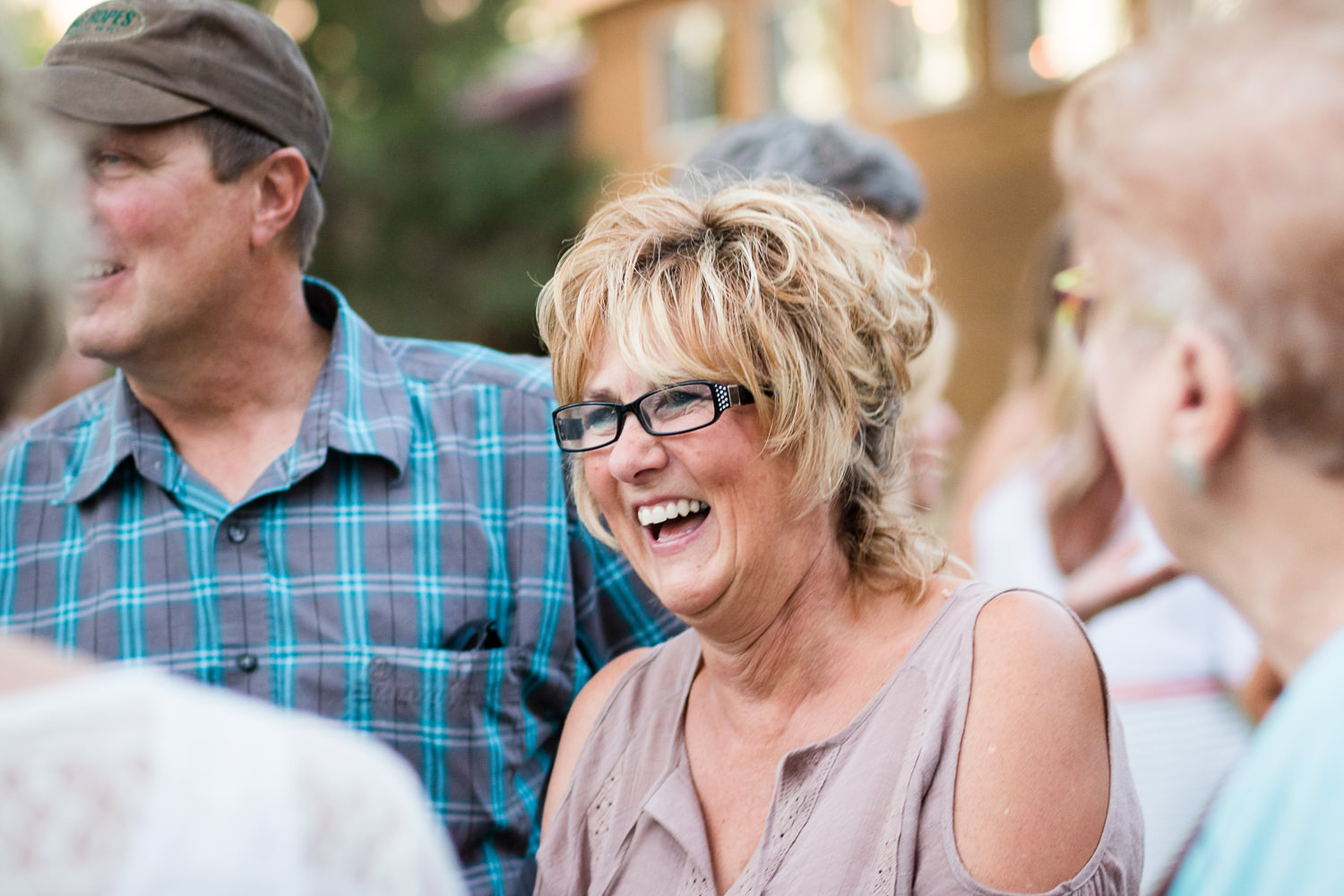 billings-montana-swift-river-ranch-wedding-reception-guests-laughing-outside.jpg