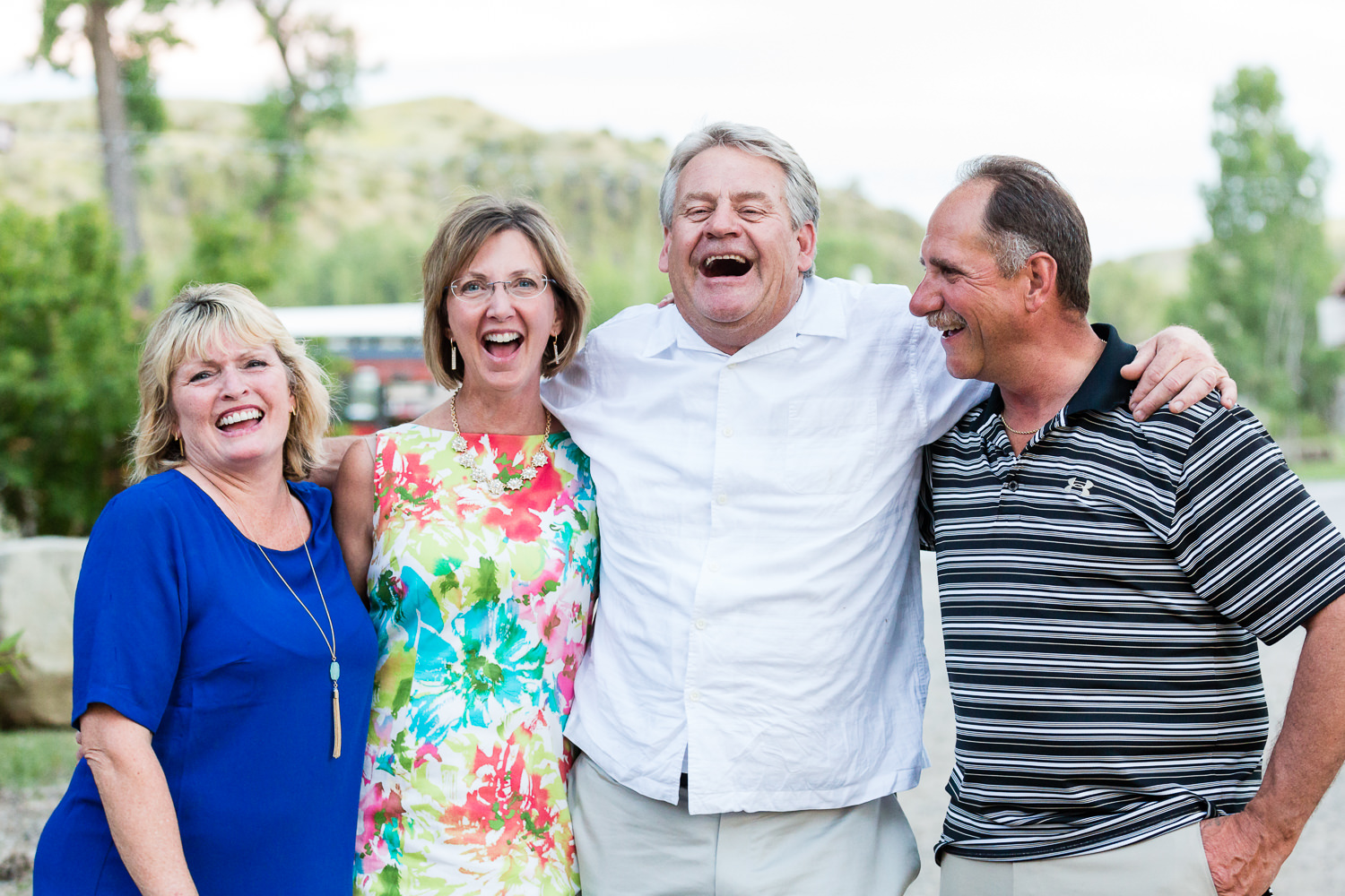 billings-montana-swift-river-ranch-wedding-reception-guests-laughing-at-sunset.jpg