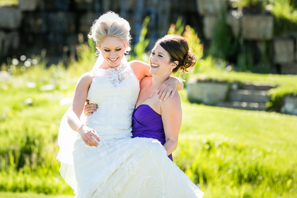 red-lodge-montana-wildflower-wedding-bridesmaid-carries-bride.jpg