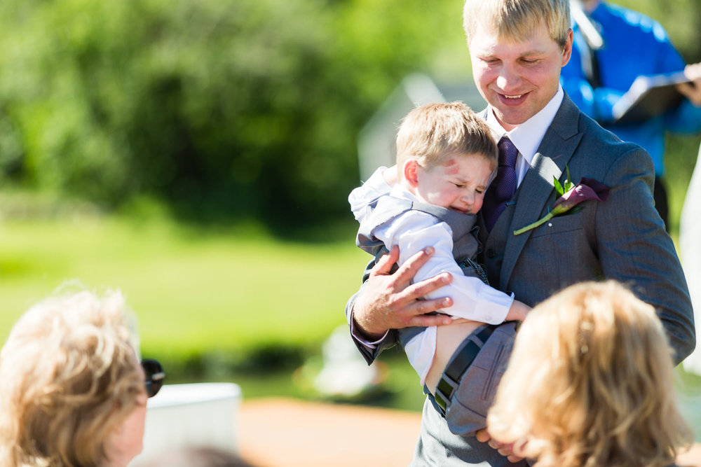 red-lodge-montana-wildflower-wedding-father-hugs-son-during-ceremony.jpg