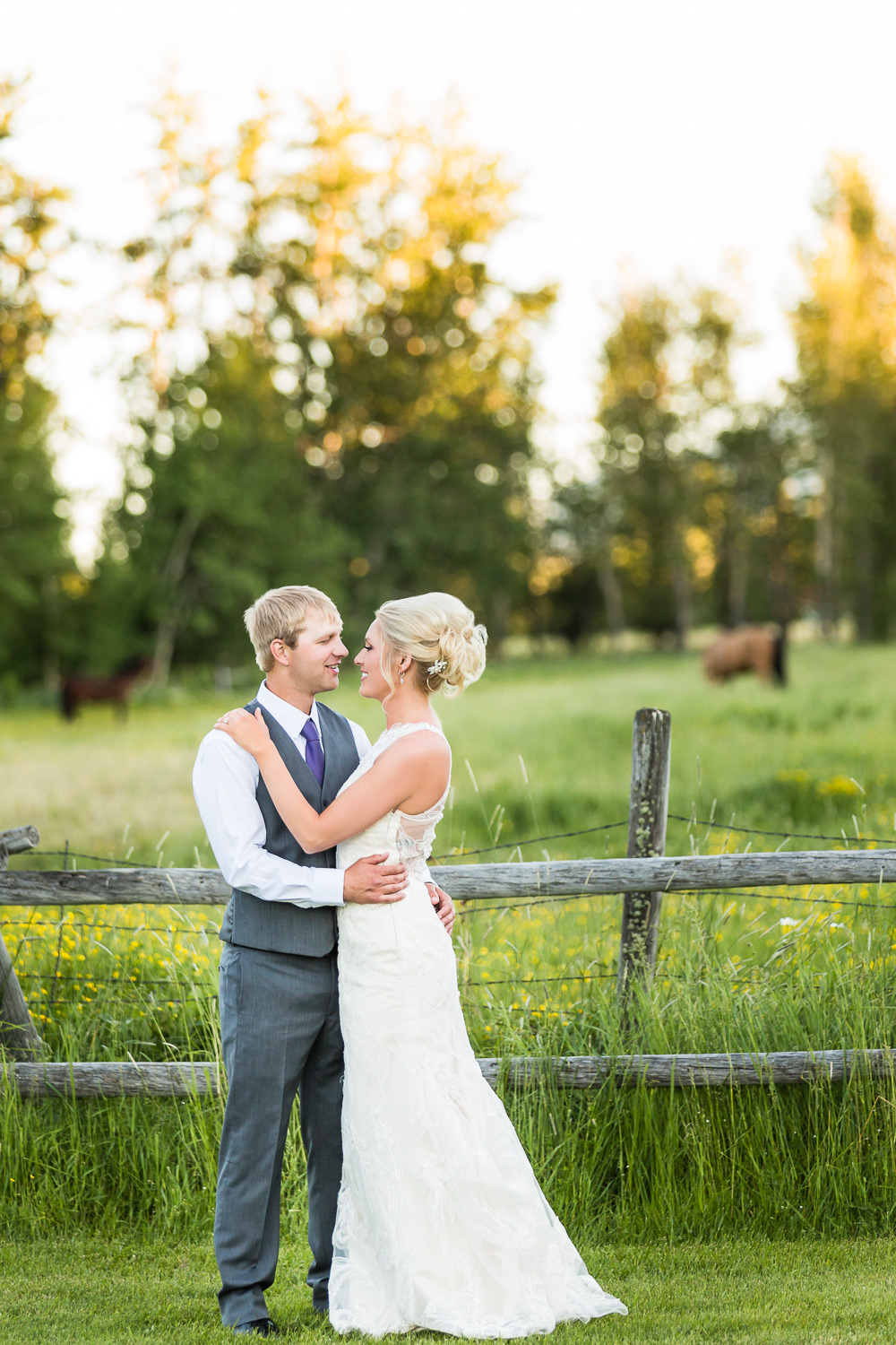 red-lodge-montana-wildflower-wedding-couple-against-fence.jpg