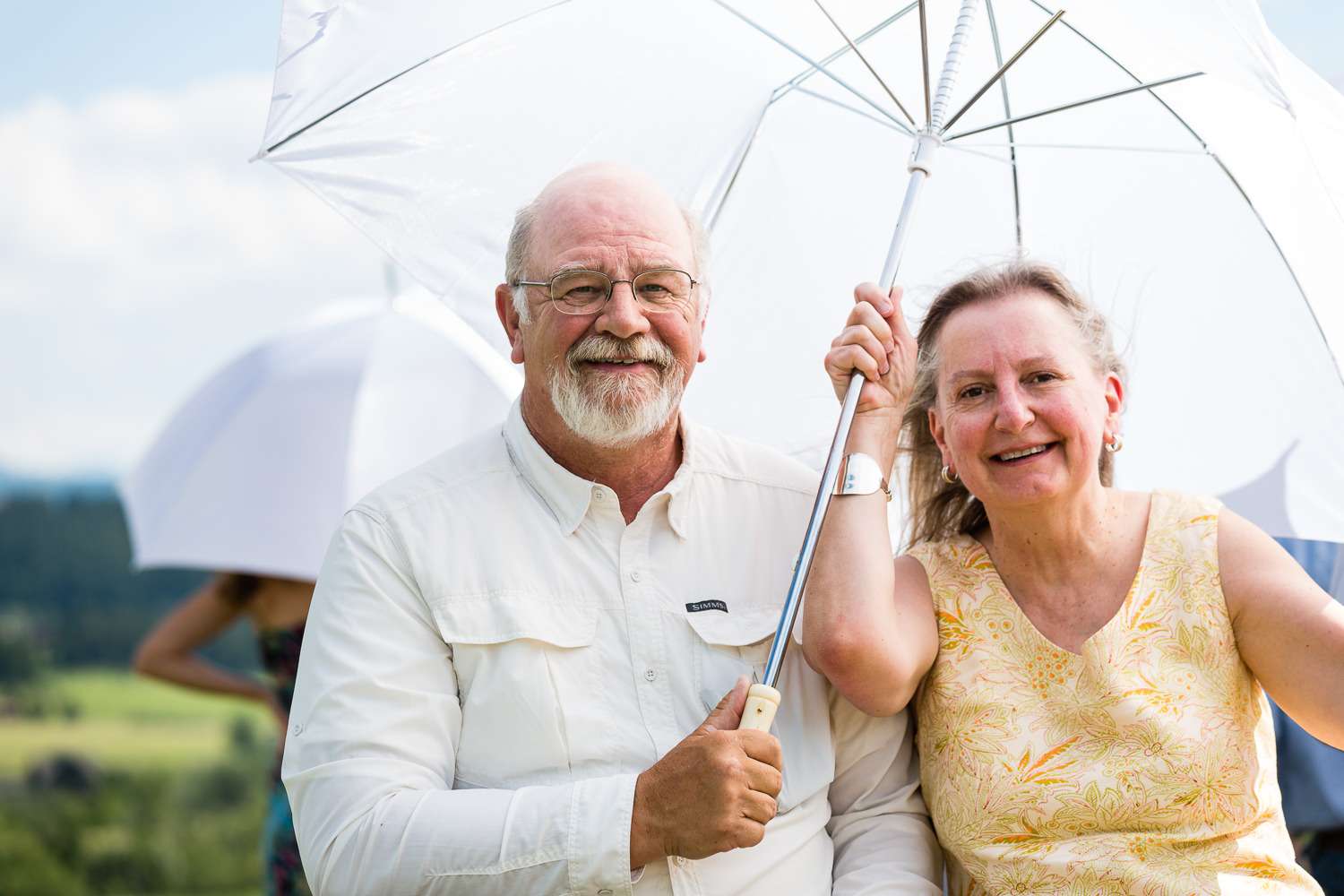 bozeman-montana-wedding-guests-enjoying-umbrella-shade.jpg