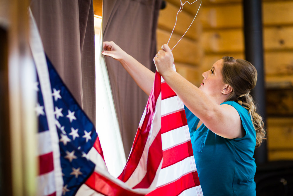 bozeman-montana-wedding-roys-barn-bridesmaid-hangs-flag.jpg