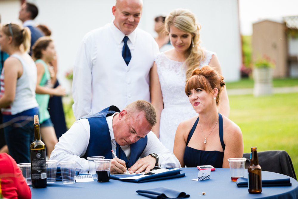 bozeman-montana-wedding-roys-barn-best-man-signs-license.jpg