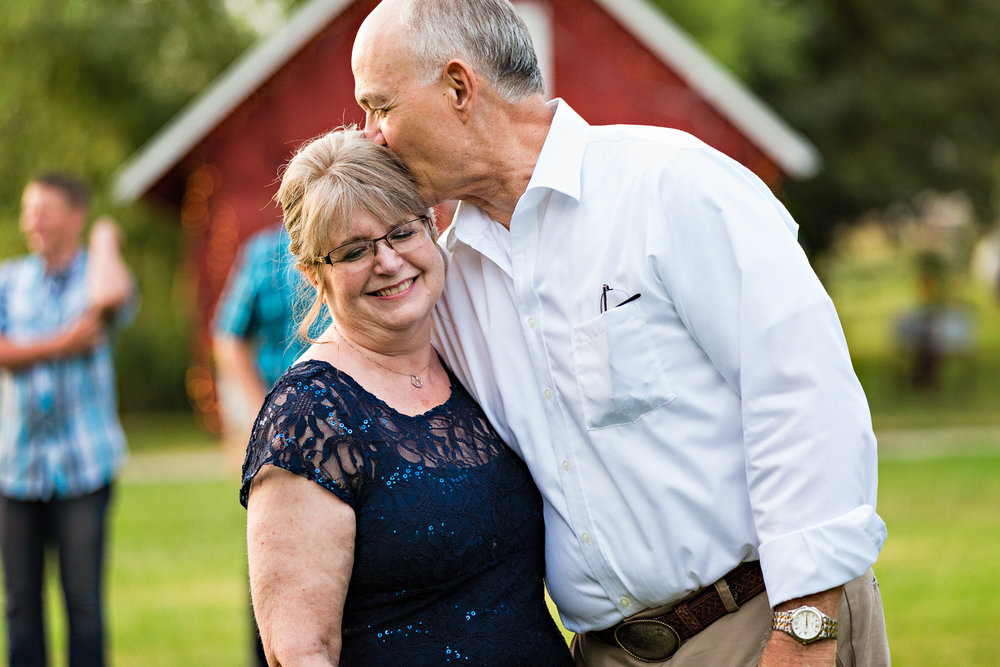 bozeman-montana-wedding-roys-barn-brides-father-kisses-wife.jpg