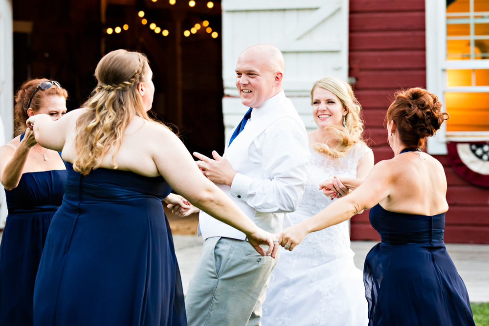 bozeman-montana-wedding-roys-barn-bridesmaids-dance-around-groom.jpg