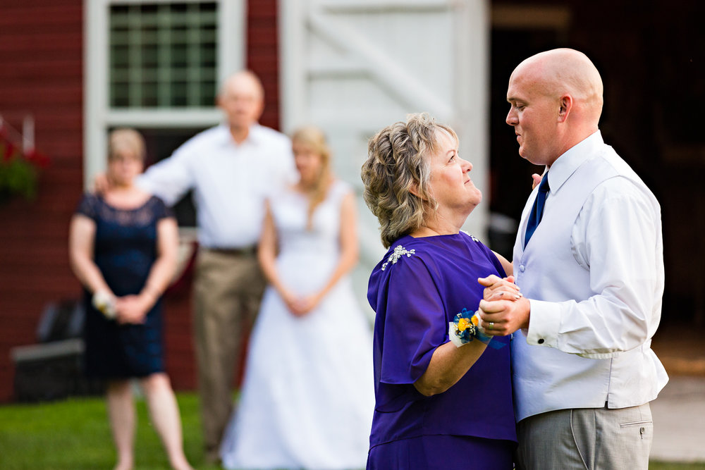 bozeman-montana-wedding-roys-barn-groom-mother-dance-with-bride-in-background.jpg