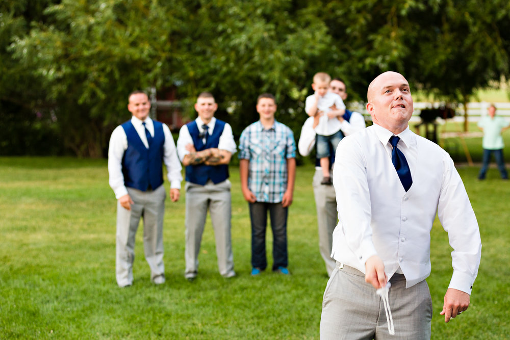 bozeman-montana-wedding-roys-barn-groom-tosses-garter.jpg