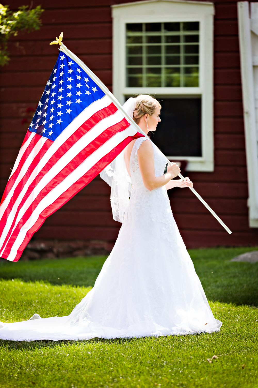 bozeman-montana-wedding-roys-barn-bride-carrying-american-flag.jpg