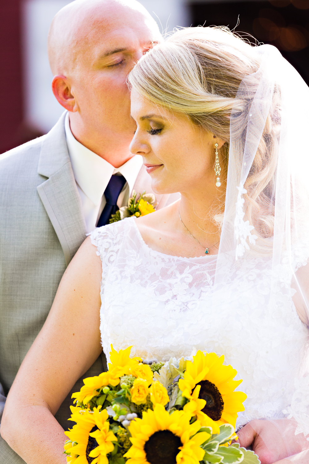 bozeman-montana-wedding-roys-barn-groom-kisses-brides-forehead.jpg