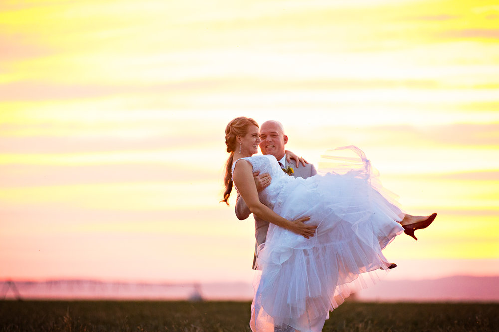 bozeman-montana-wedding-roys-barn-groom-picks-up-bride.jpg