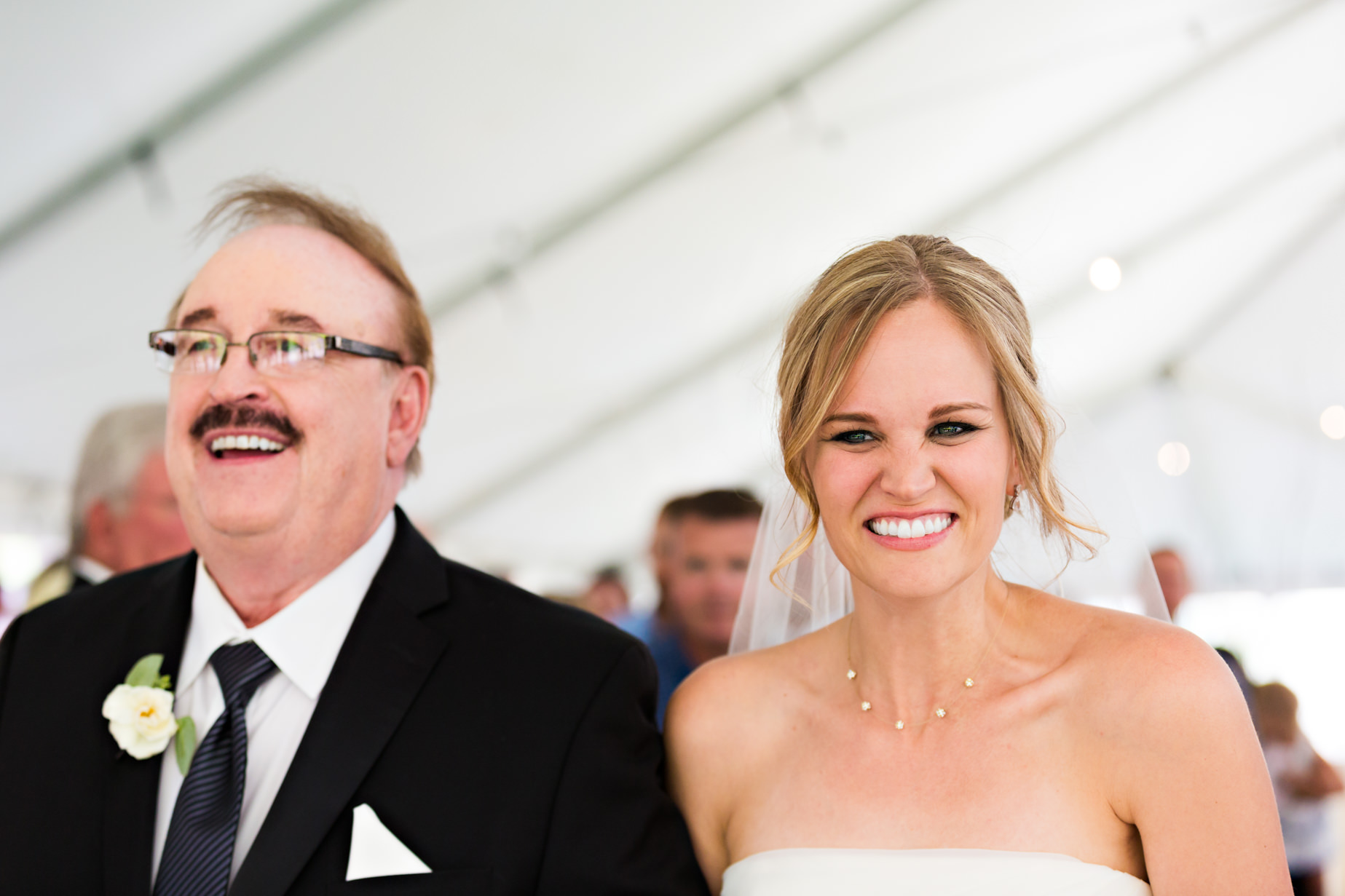 big-sky-resort-wedding-bride-smiles-at-groom-while-walking-up-aisle.jpg