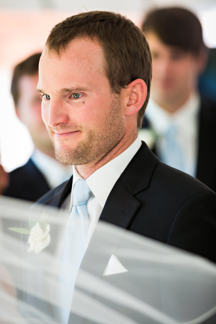 big-sky-resort-wedding-groom-looks-at-bride-during-ceremony.jpg