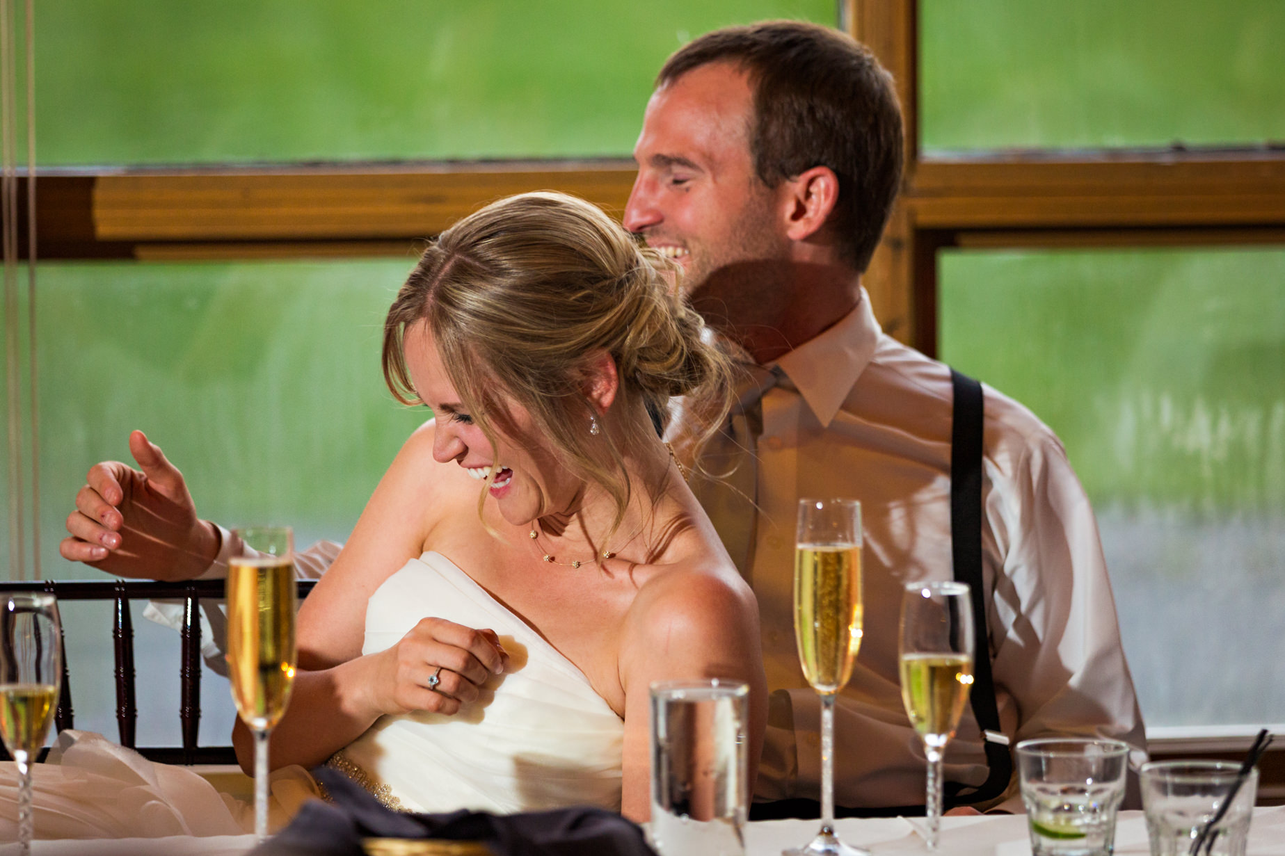 big-sky-resort-wedding-bride-groom-laugh-during-toasts.jpg