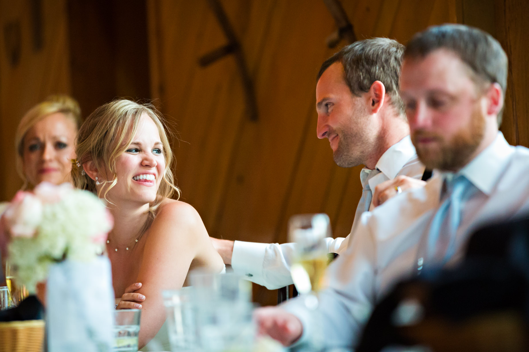 big-sky-resort-wedding-bride-looking-at-groom-during-meal.jpg