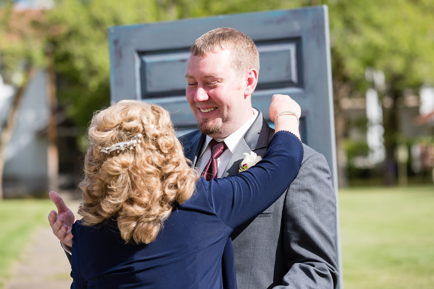 heritage-hall-missoula-montana-groom-hugs-mother-in-law-ceremony.jpg