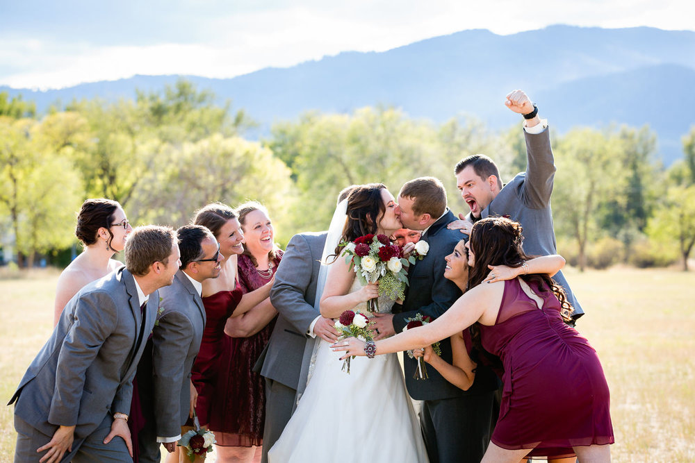 heritage-hall-missoula-montana-wedding-party-cheers-during-kiss.jpg
