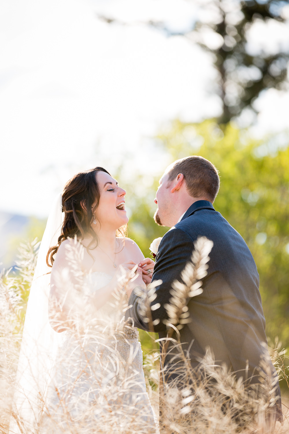 heritage-hall-missoula-montana-bride-groom-laughing-in-field.jpg