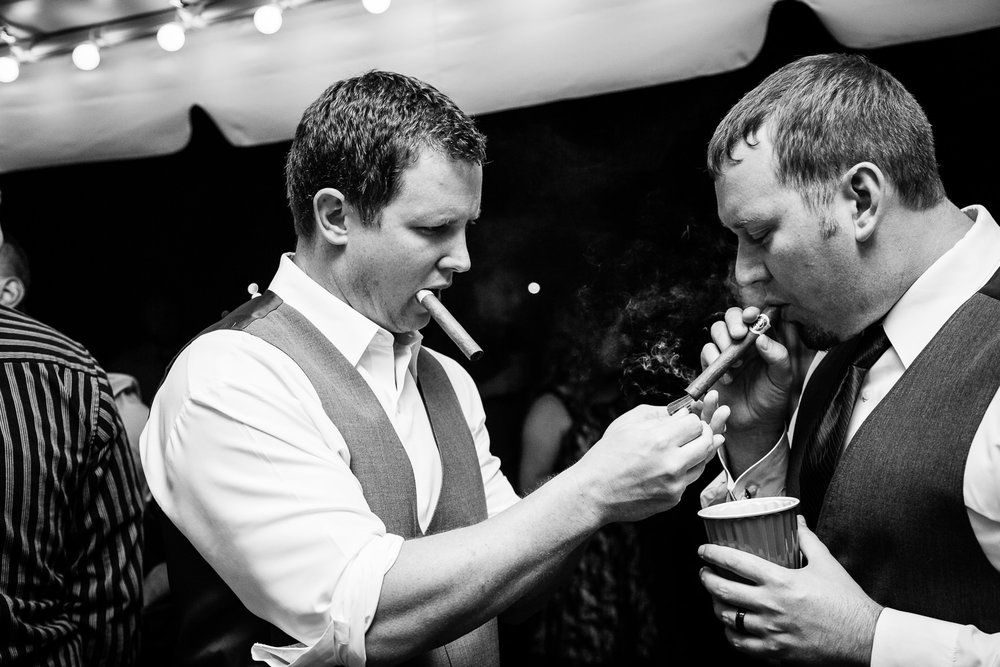 heritage-hall-missoula-montana-best-man-lights-grooms-cigar.jpg