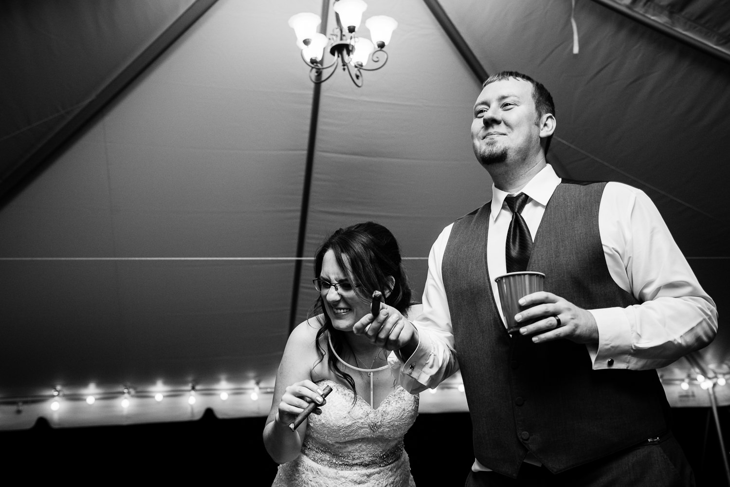 heritage-hall-missoula-montana-bride-laughs-groom-smokes-cigar.jpg