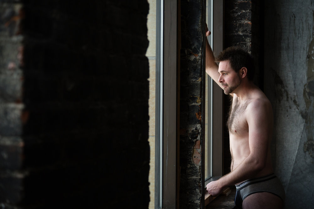 montana-male-boudoir-photoshoot-man-arms-around-window.jpg