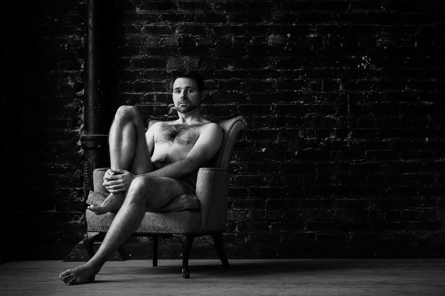 montana-male-boudoir-photoshoot-man-holding-leg-sitting-in-chair.jpg