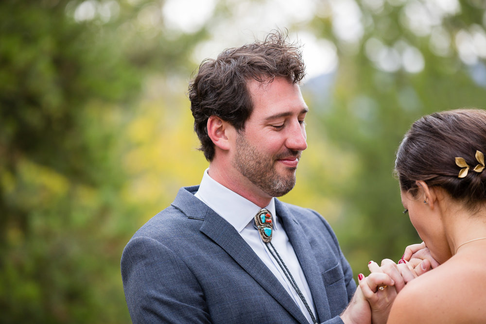 big-sky-montana-gallatin-riverhouse-wedding-bride-kisses-grooms-hands.jpg