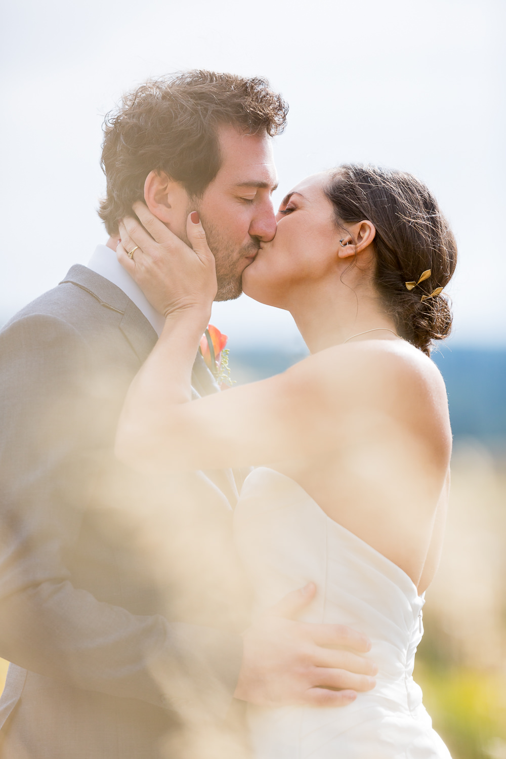 big-sky-montana-gallatin-riverhouse-wedding-bride-groom-kissing-in-grass.jpg