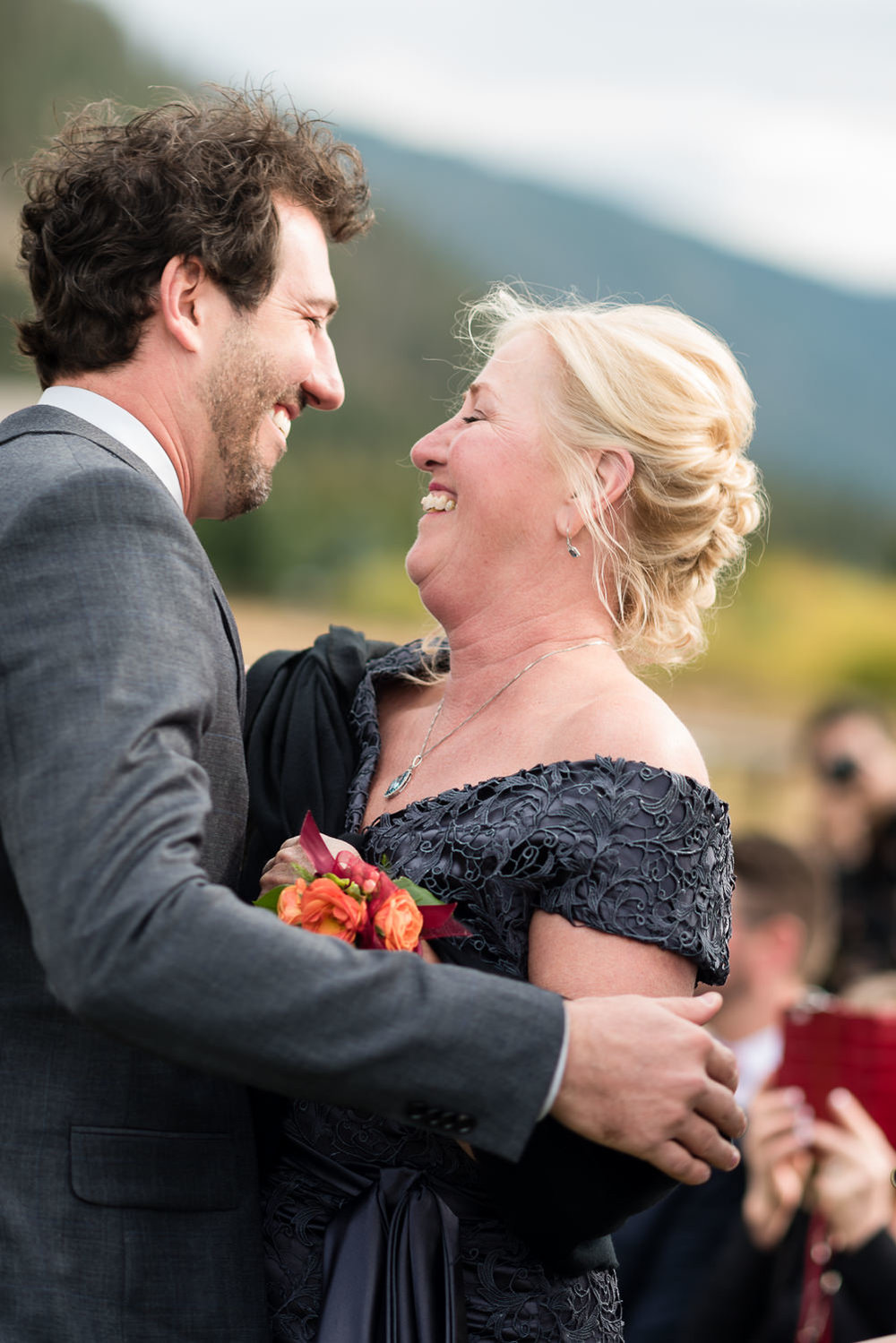 big-sky-montana-gallatin-riverhouse-wedding-groom-hugs-mom-before-ceremony.jpg